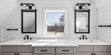 Double vanity with black fixtures and white shiplap walls by Doxa Custom Homes
