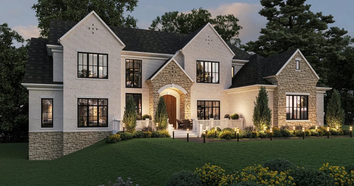 Custom home exterior with white brick, black windows, and landscaped lighting by Do