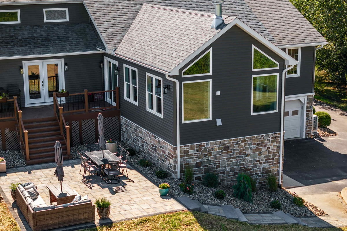 Back view of a Middle Tennessee custom home featuring a large patio and composite decking by Doxa Custom Homes