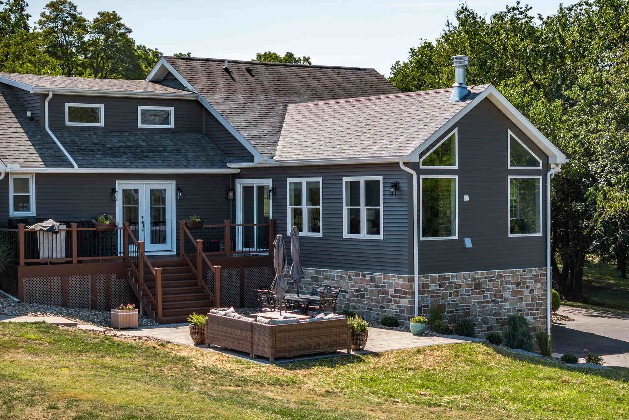 Back view of modern custom home with stone accents in Cookeville, TN by Doxa Custom Homes