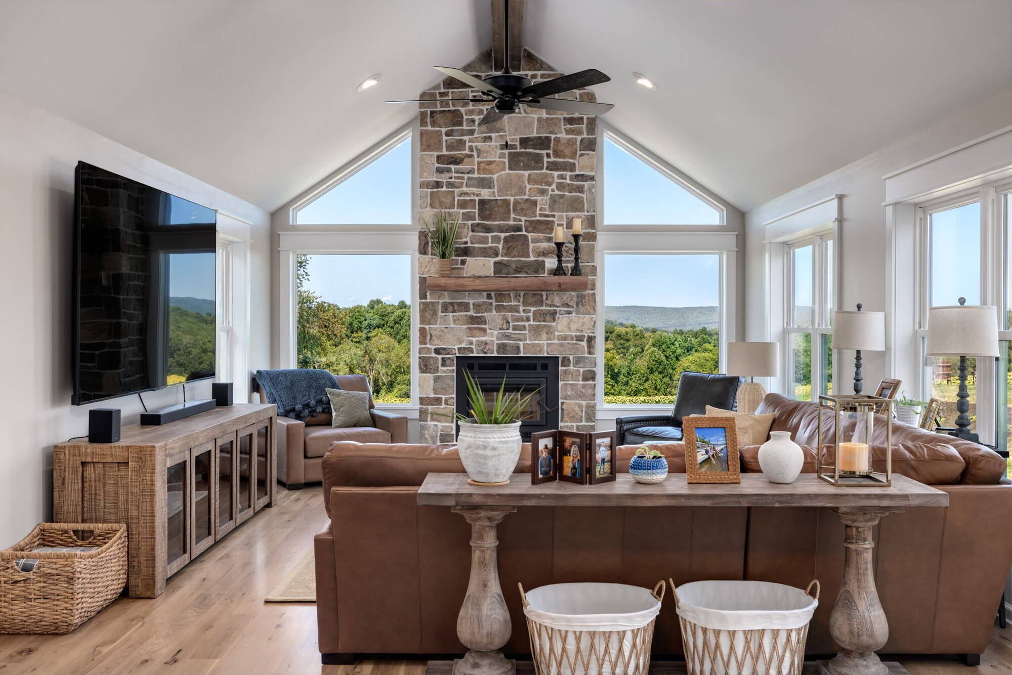 Living room with vaulted ceiling and stone fireplace in custom home by Doxa Custom Homes in Cookeville, TN