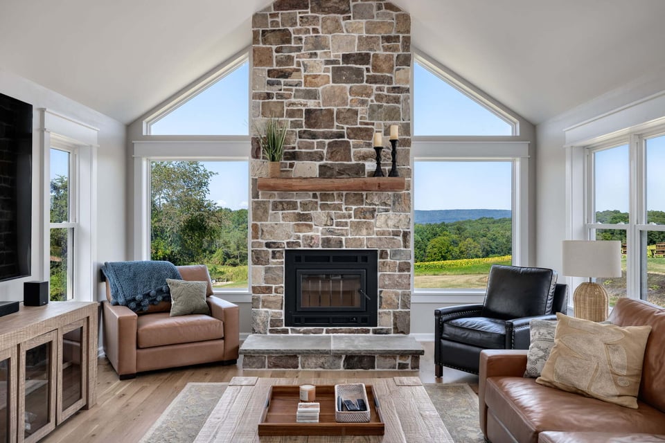 Stone fireplace with wood mantel in custom living room by Doxa Custom Homes in Murfreesboro, TN