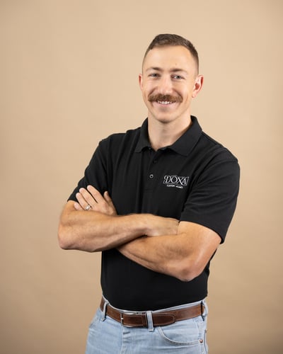 The owner of Doxa Custom Homes standing with arms folded, representing custom home projects in Crossville, TN