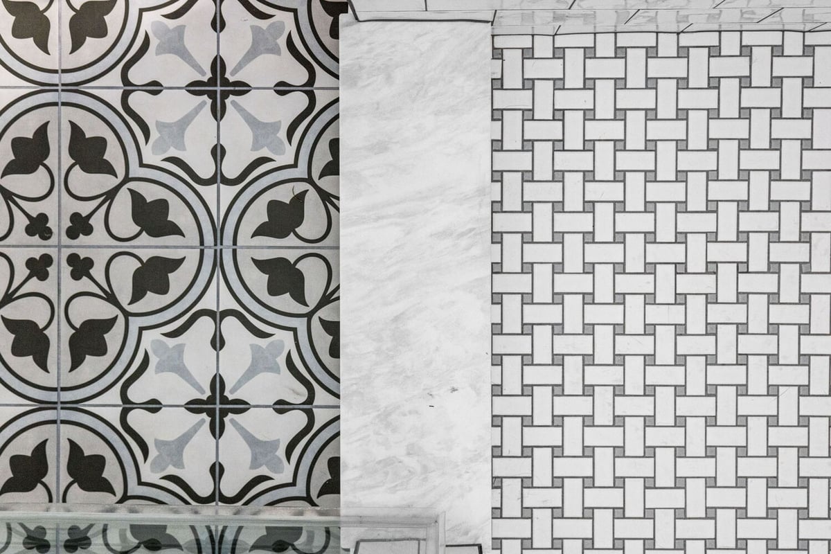 Custom bathroom flooring with mosaic and floral tiles by Doxa Custom Homes in Cookeville, Tennessee