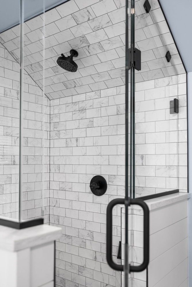 Detailed look at tiled shower ceiling and black fixtures by Doxa Custom Homes in Cookeville, Tennessee