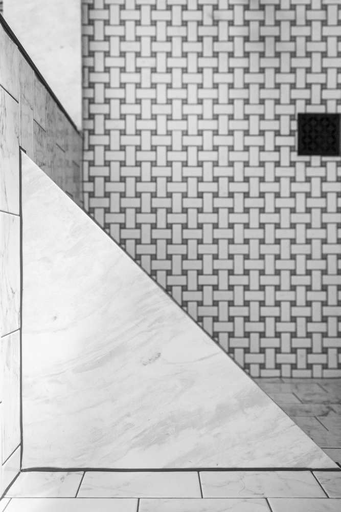 Walk-in shower wall featuring white marble tile in a Doxa Custom Homes project in Tennessee