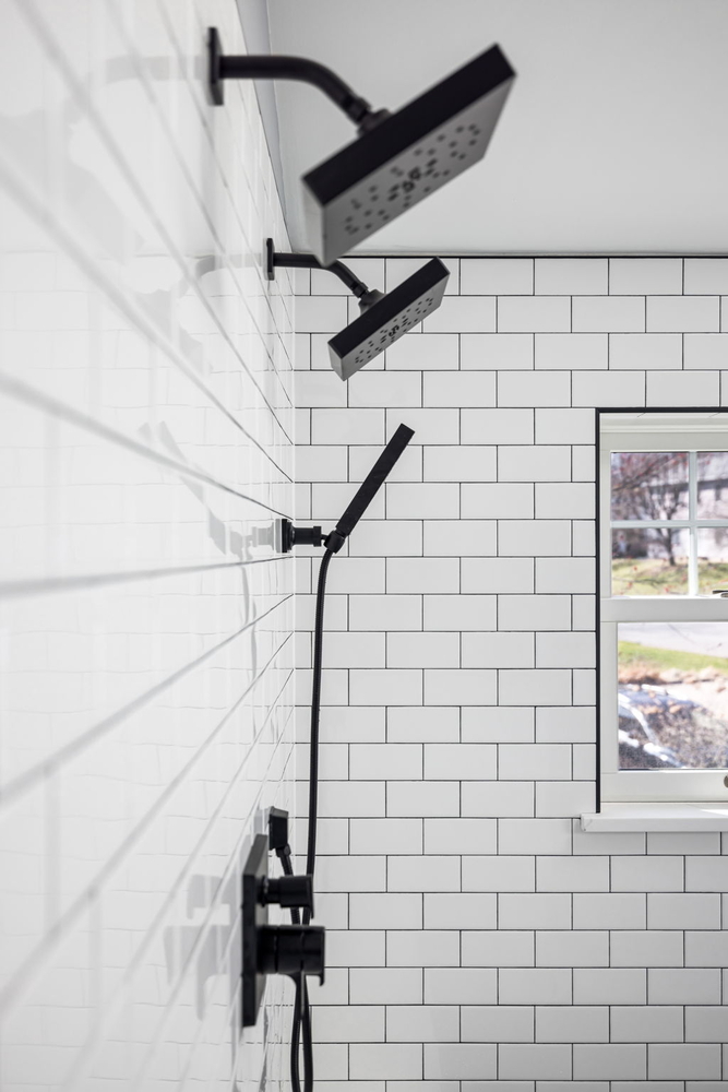 Custom shower with dual black showerheads by Doxa Custom Homes in Murfreesboro, TN