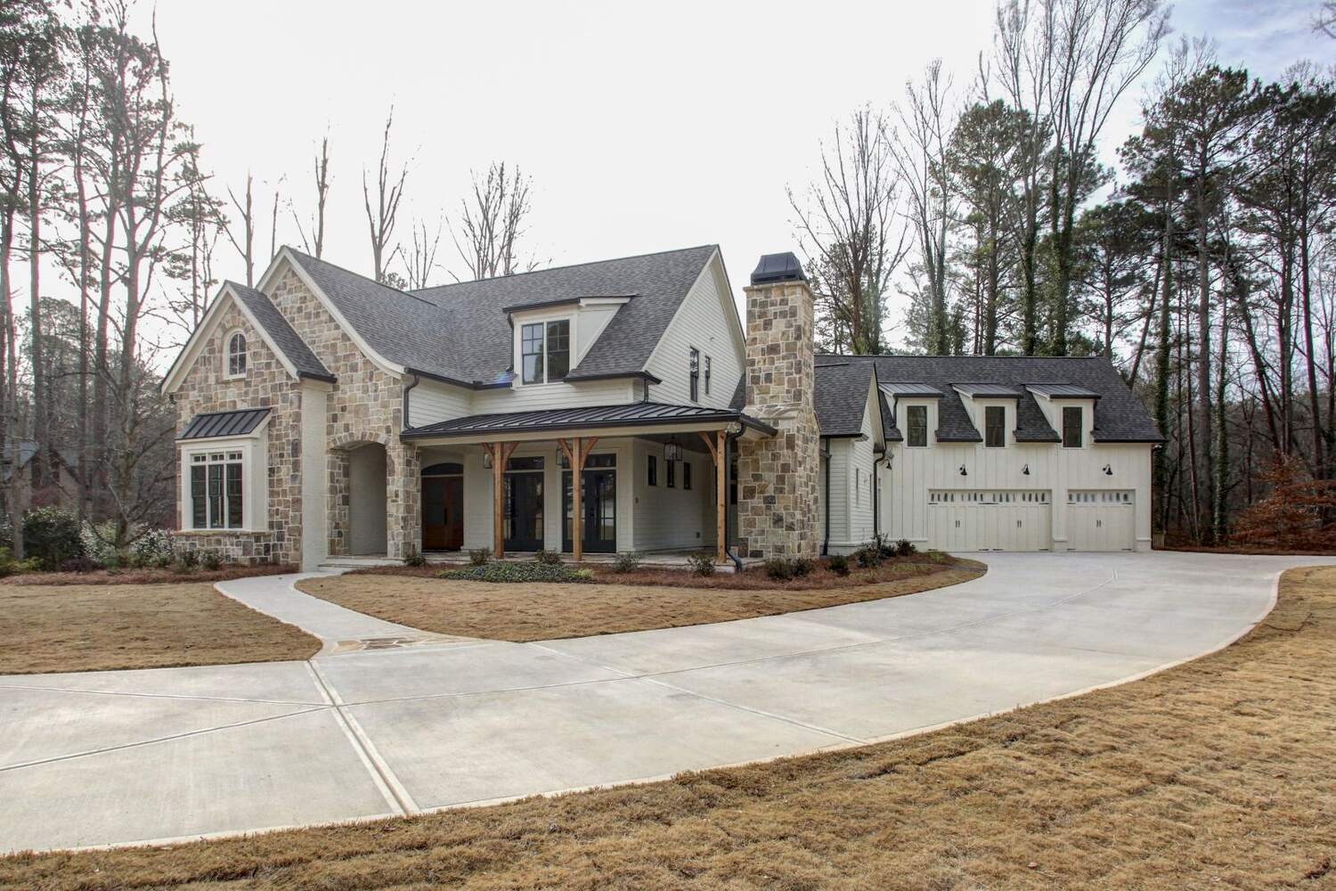Front view of stone and siding custom home with large driveway by Doxa Custom Homes in Crossville, TN Front view of stone and siding custom home with large driveway by Doxa Custom Homes in Crossville, TN