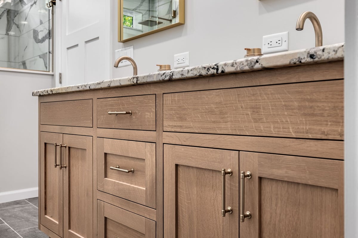 Dual sink vanity with wood cabinetry and granite counters in Crossville custom home by Doxa Custom Homes