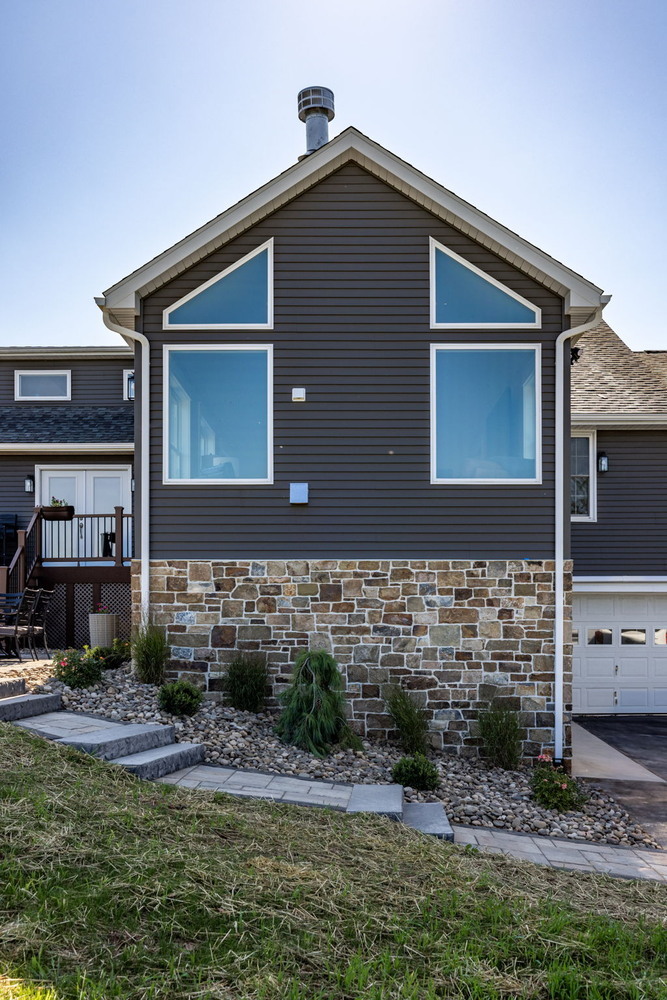 Triangular window facade of custom home addition by Doxa Custom Homes in Lebanon, TN