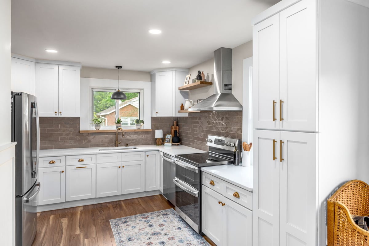 Custom white kitchen with brass hardware and stainless steel appliances by Doxa Custom Homes in Murfreesboro, TN