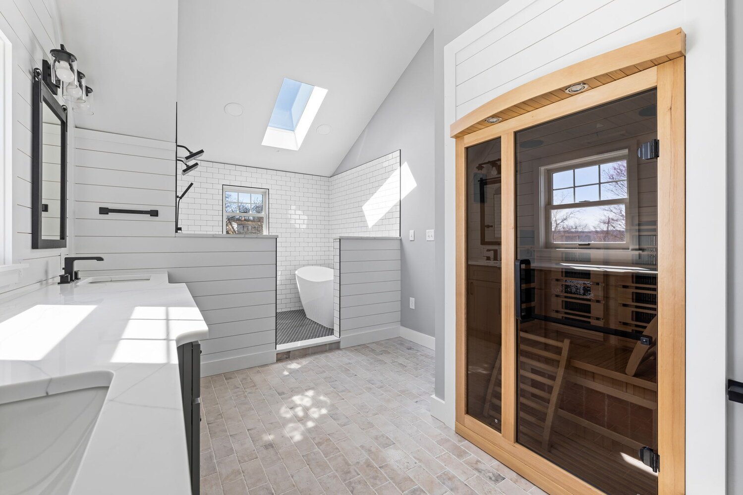 Luxury bathroom with sauna, shower, and freestanding tub by Doxa Custom Homes in Crossville, TN