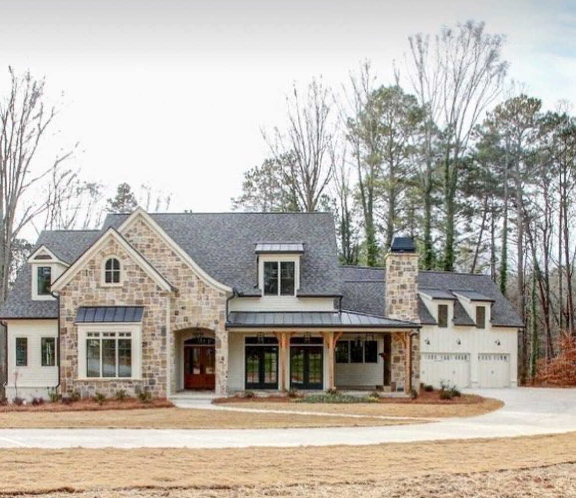Two-story custom house with stone façade and three-car garage by Doxa Custom Homes in Murfreesboro, Tennessee