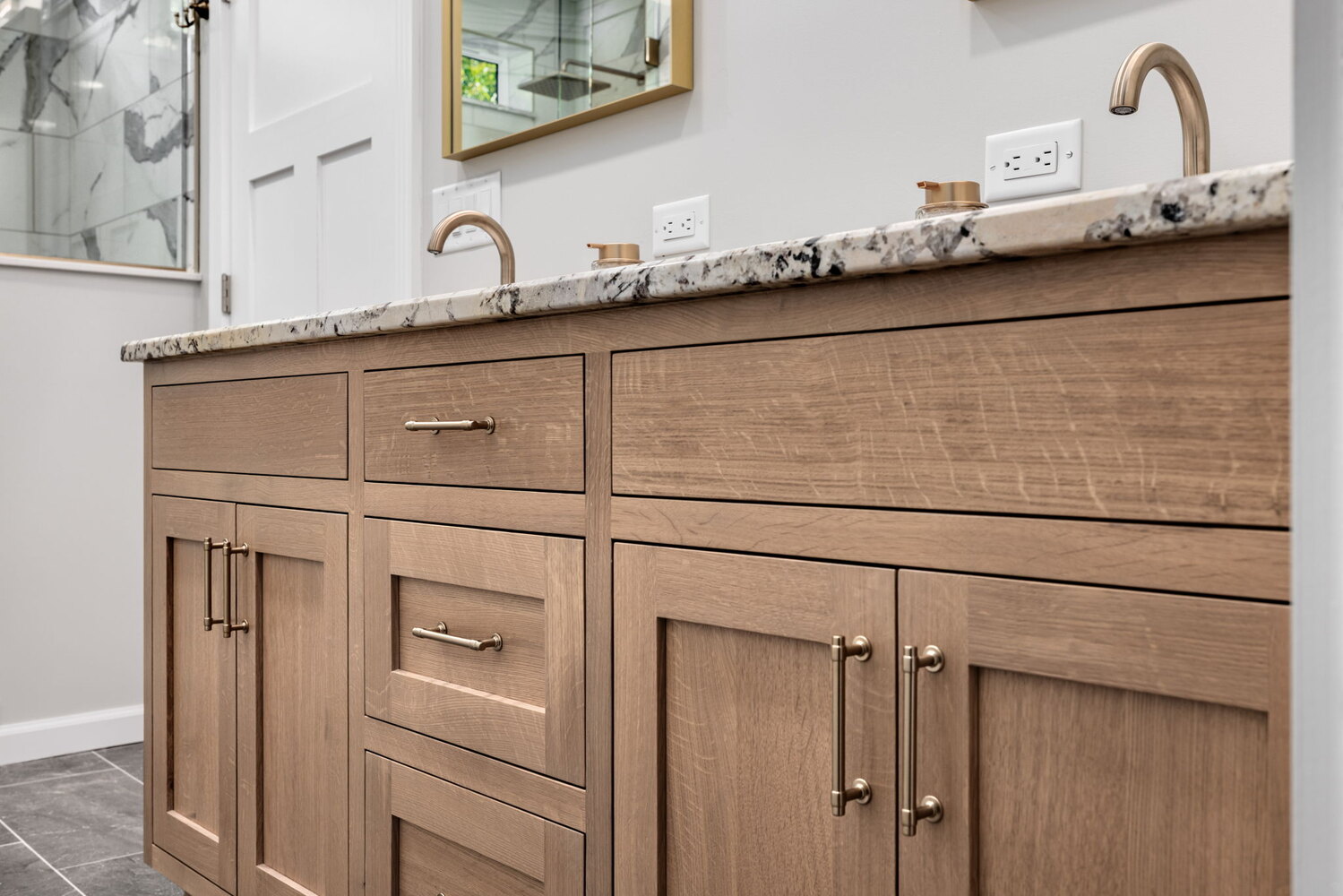 Dual sink vanity with wood cabinetry and granite counters in Crossville custom home by Doxa Custom Homes