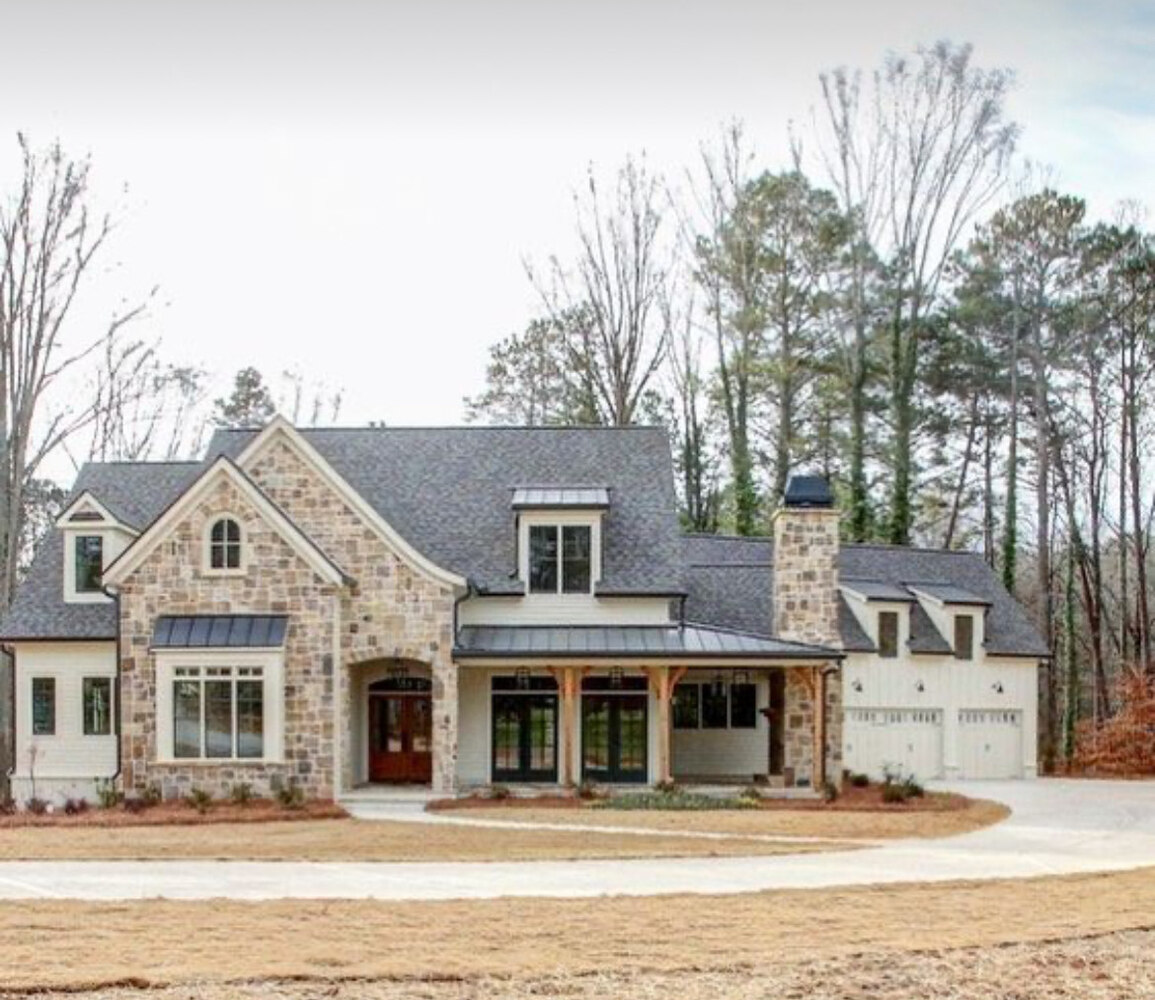 Front view of a large Tennessee custom home featuring wood beams, stone accents, and dormer windows by Doxa Custom Homes